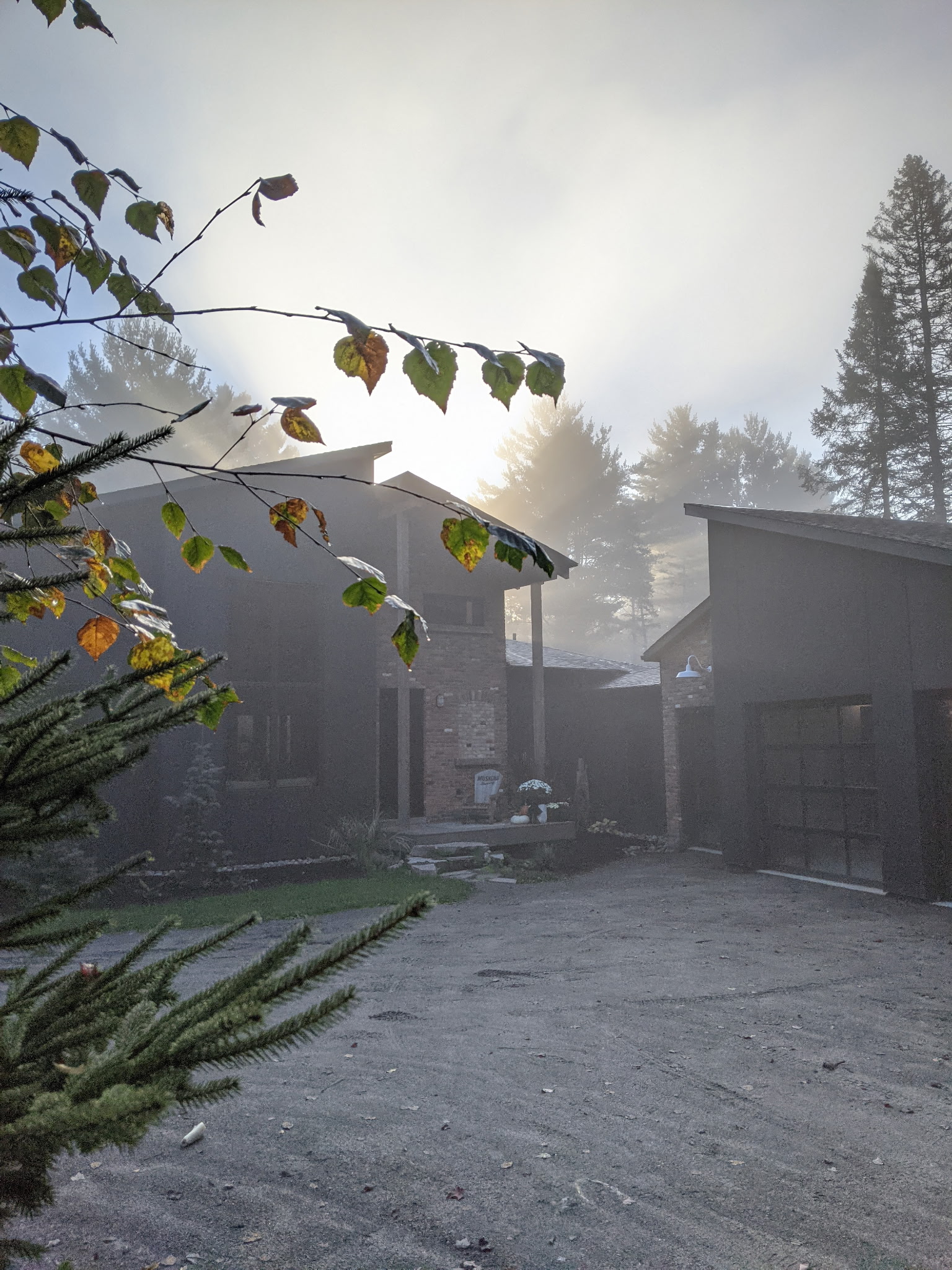 The exterior of the Arrow Ridge home, a spacious and cozy house with large windows overlooking the river and forest